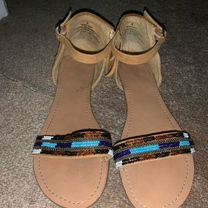 Tan ankle strap sandal with bead and fringe detail